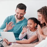 Love, video call and family in bed, smile or conversation online with tablet, bonding or chatting. .