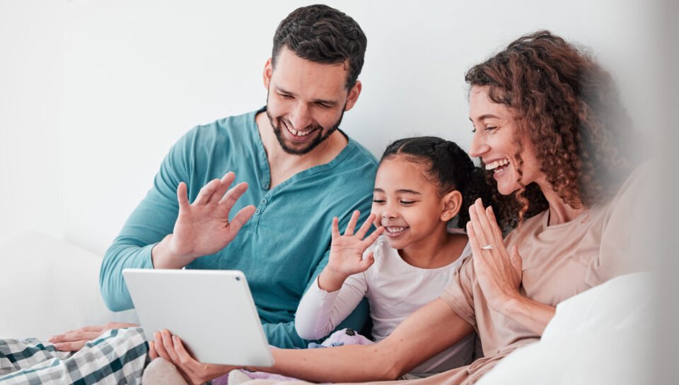 Love, video call and family in bed, smile or conversation online with tablet, bonding or chatting. .